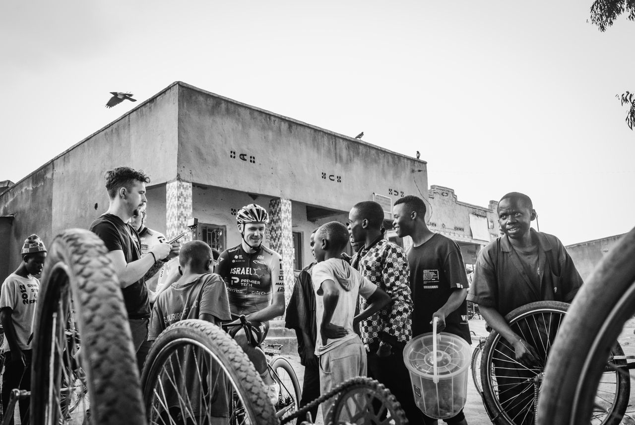 A cyclist from the Racing for Change program meeting with children in the community
